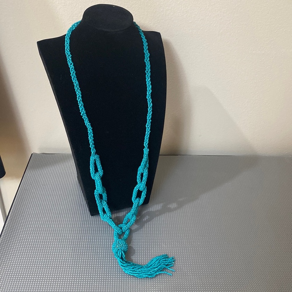 Long turquoise beaded necklace with chain links and tassel